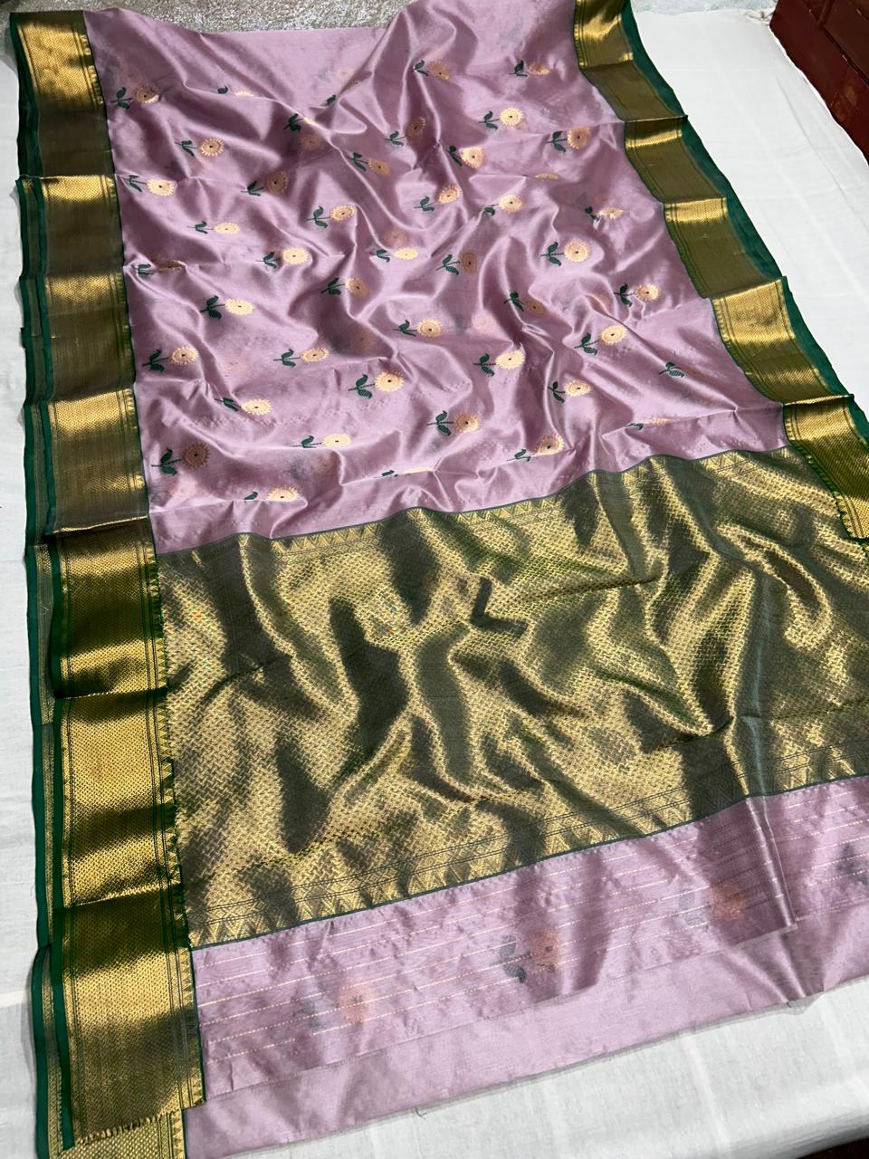 Pastel pink pattu silk saree with meena work nakshi border