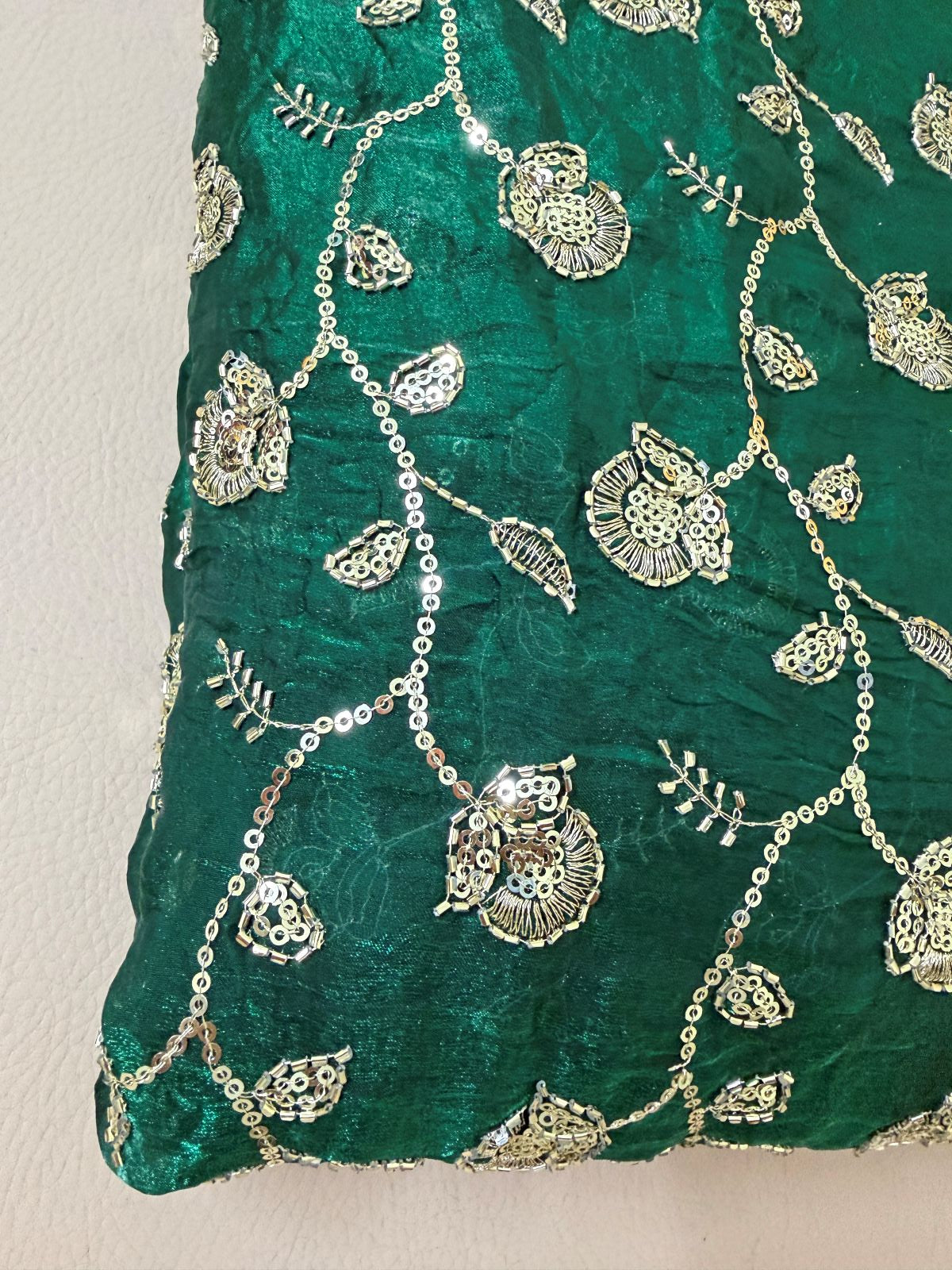 Teal green lehenga skirt laid flat showing all-over shimmer work and full flare