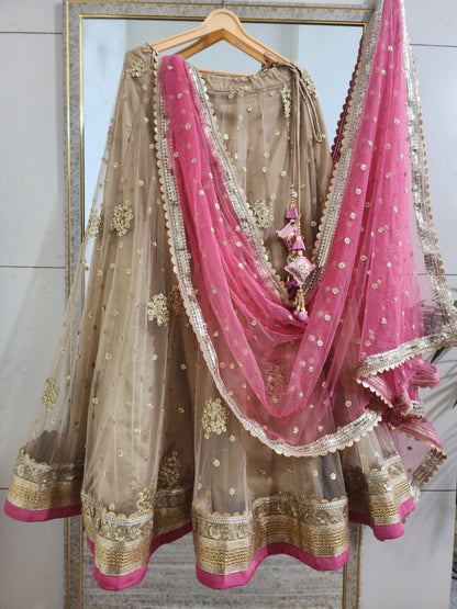 Indian designer golden lehenga with pink dupatta