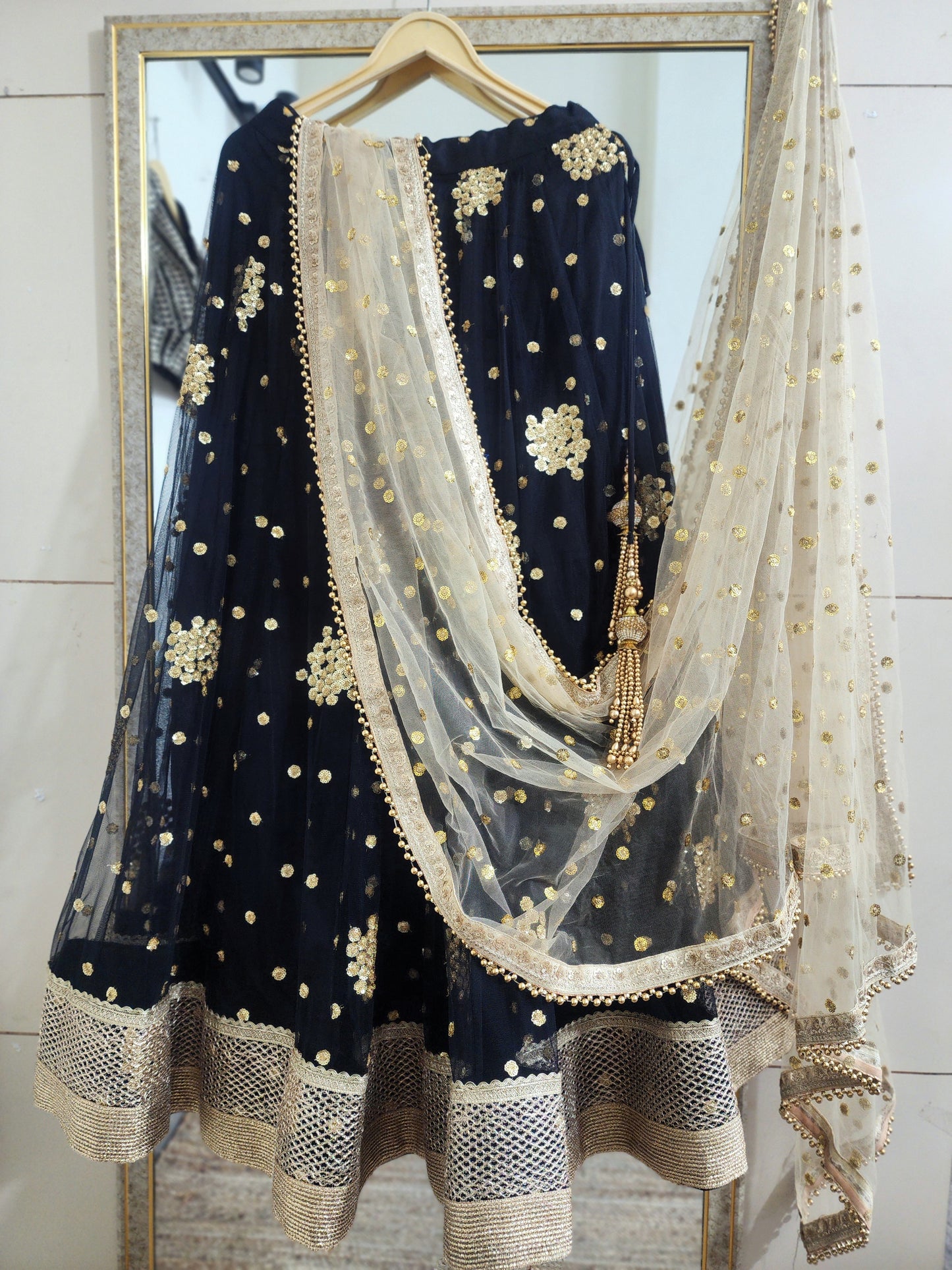 Embroidered black lehenga with golden dupatta
