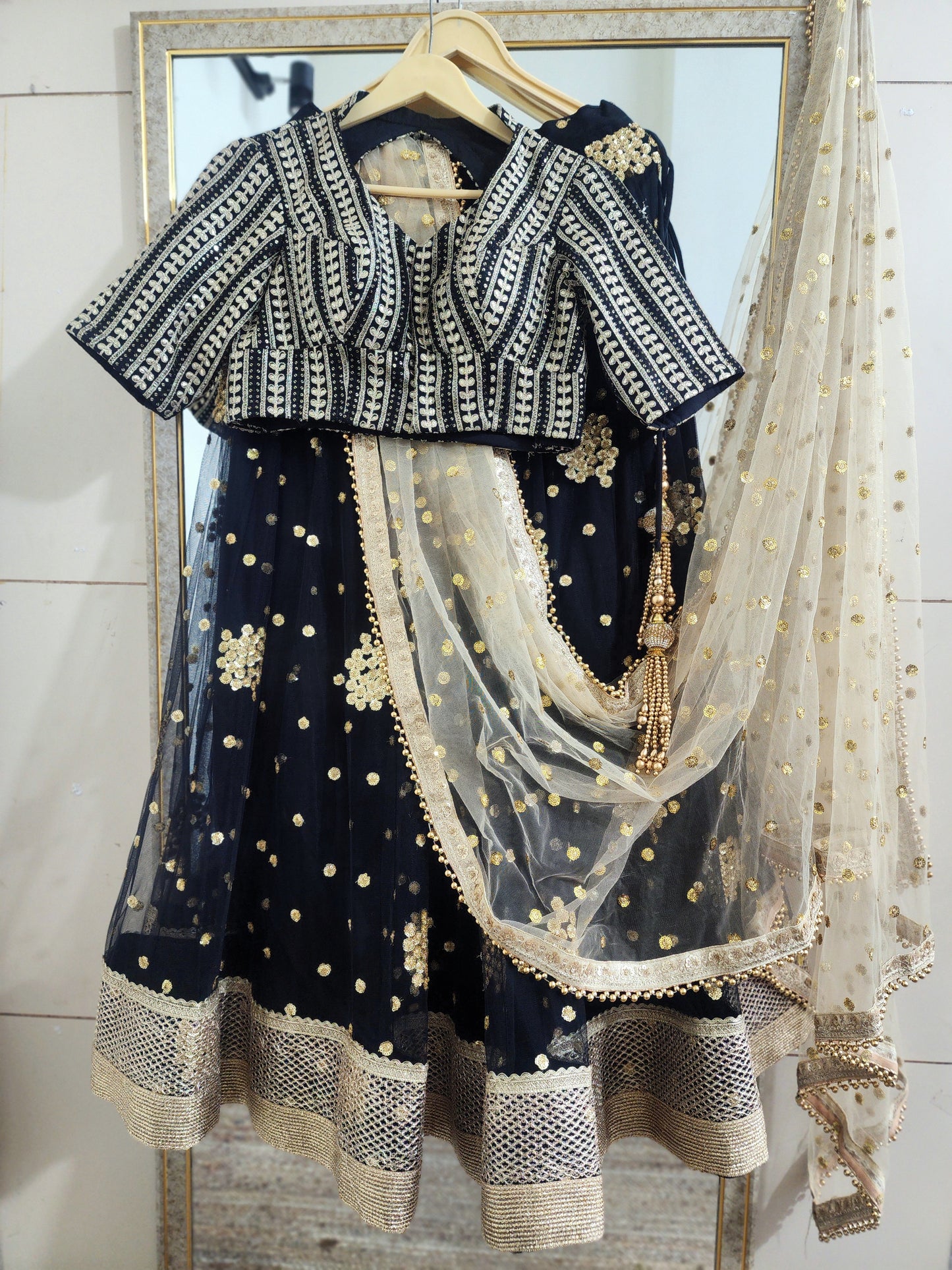 Embroidered black lehenga with golden dupatta