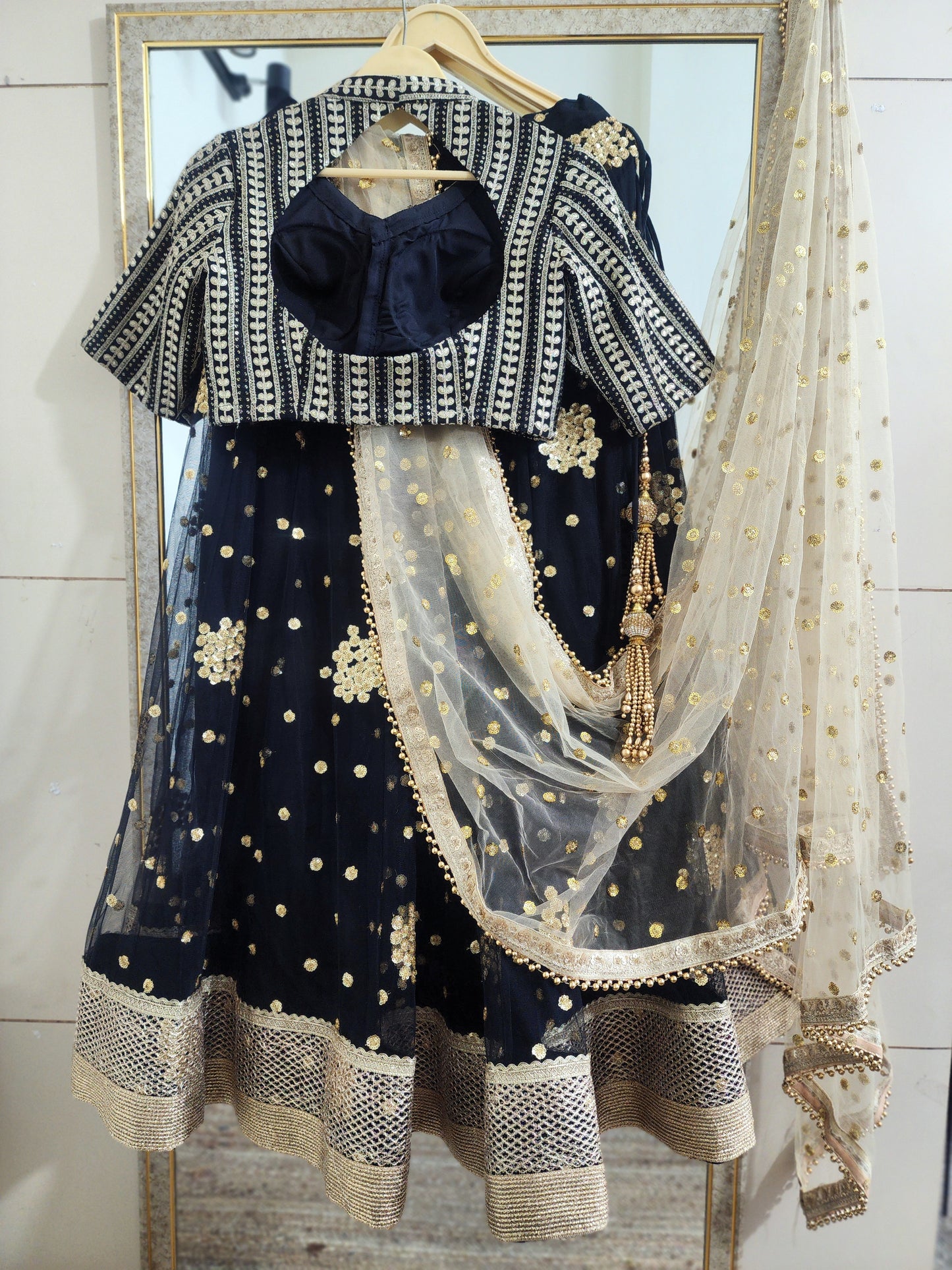 Embroidered black lehenga with golden dupatta