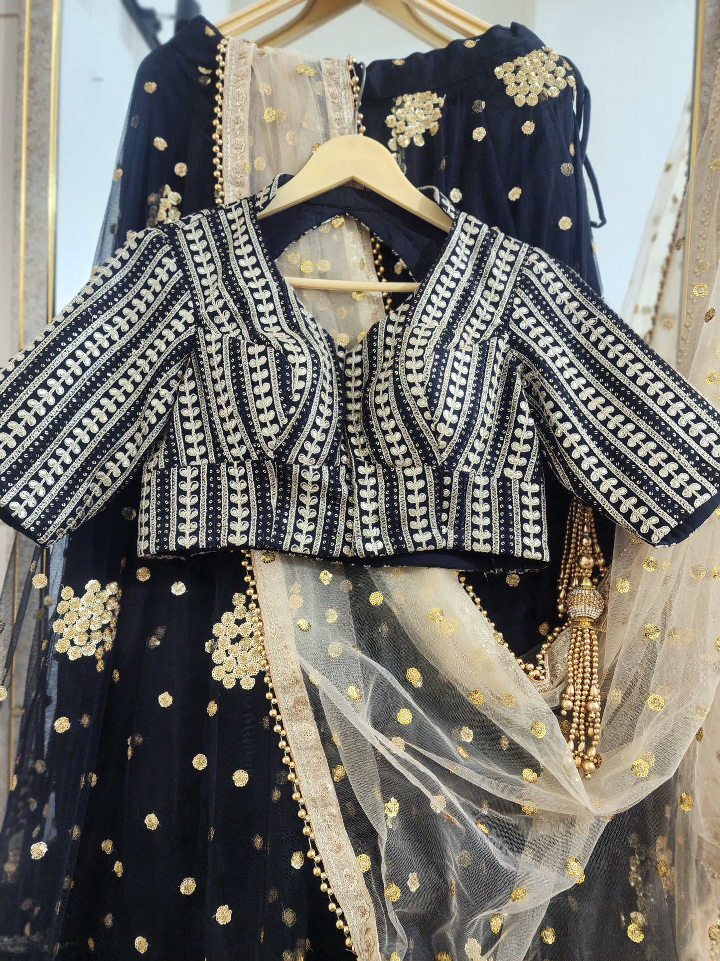 Embroidered black lehenga with golden dupatta