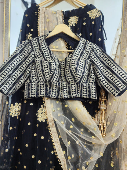Embroidered black lehenga with golden dupatta
