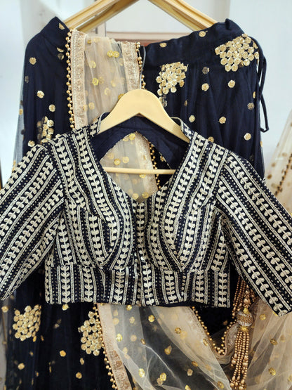 Embroidered black lehenga with golden dupatta