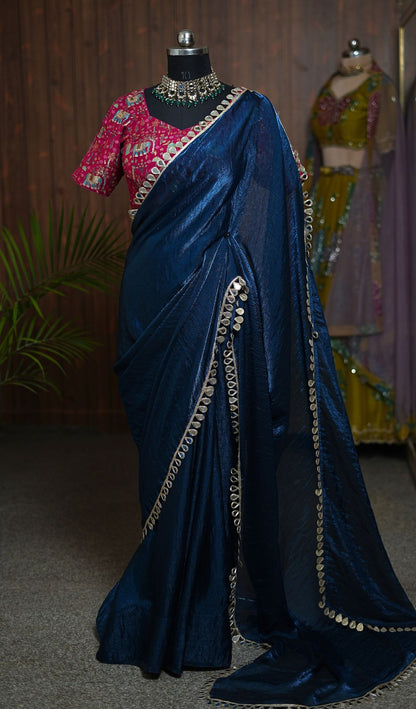 Close-up of navy blue saree with gold-toned border and pink elephant motif blouse