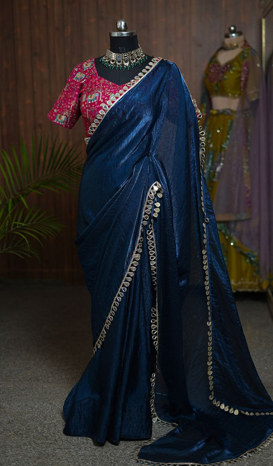 Close-up of navy blue saree with gold-toned border and pink elephant motif blouse
