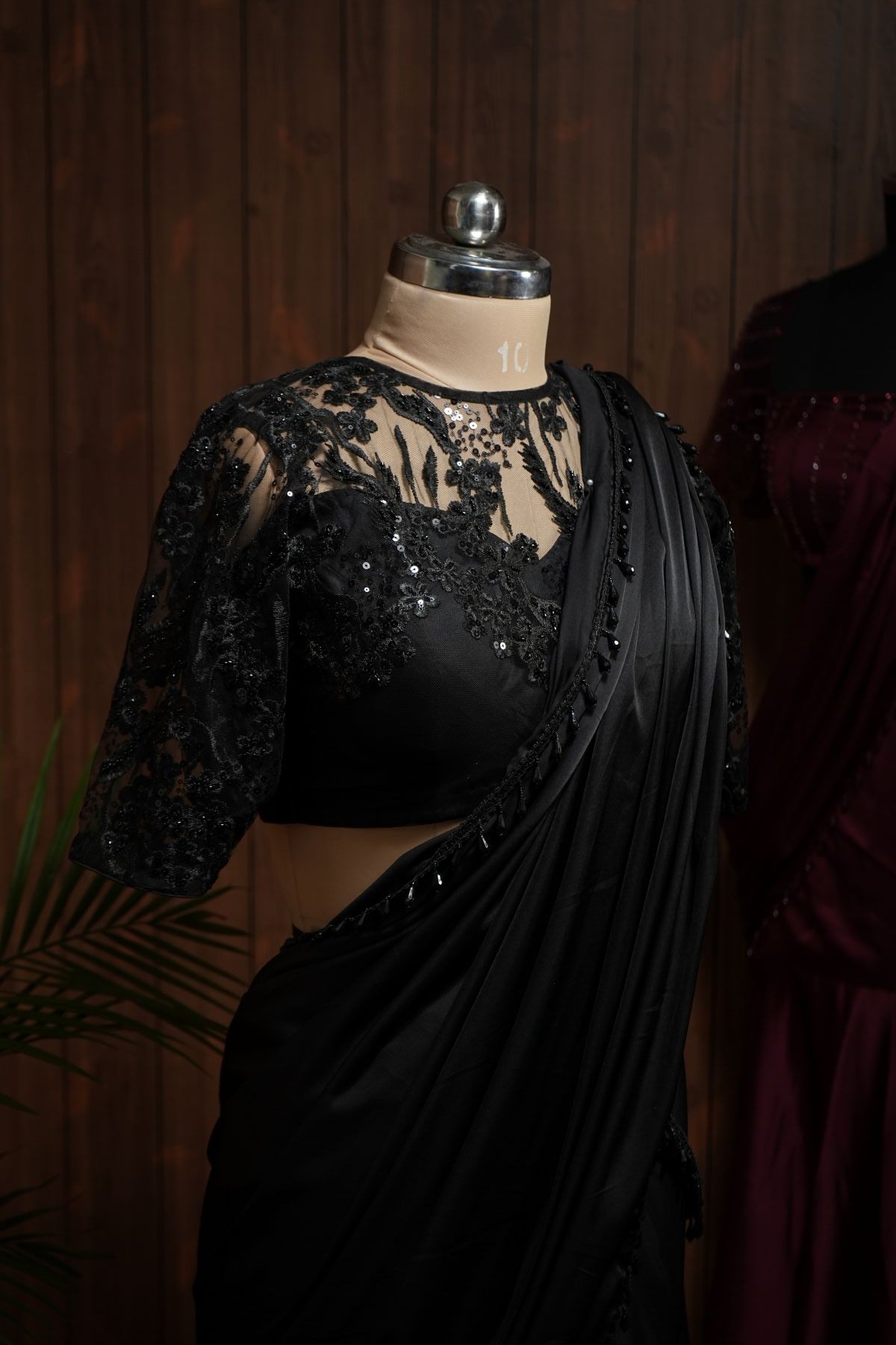 Back view of black sequin embroidered net blouse with keyhole back and tie-up
