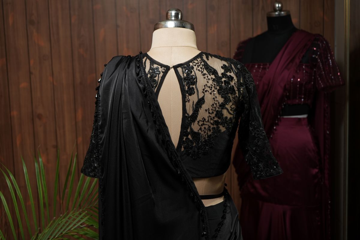 Full back view of black saree with sequin embroidered net blouse