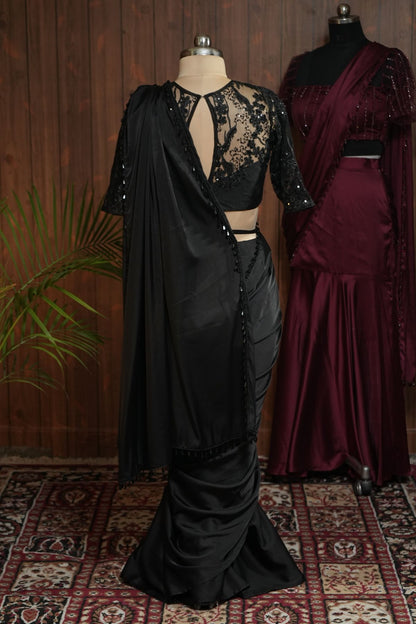 Side view of black sequin embellished net blouse with draped pallu