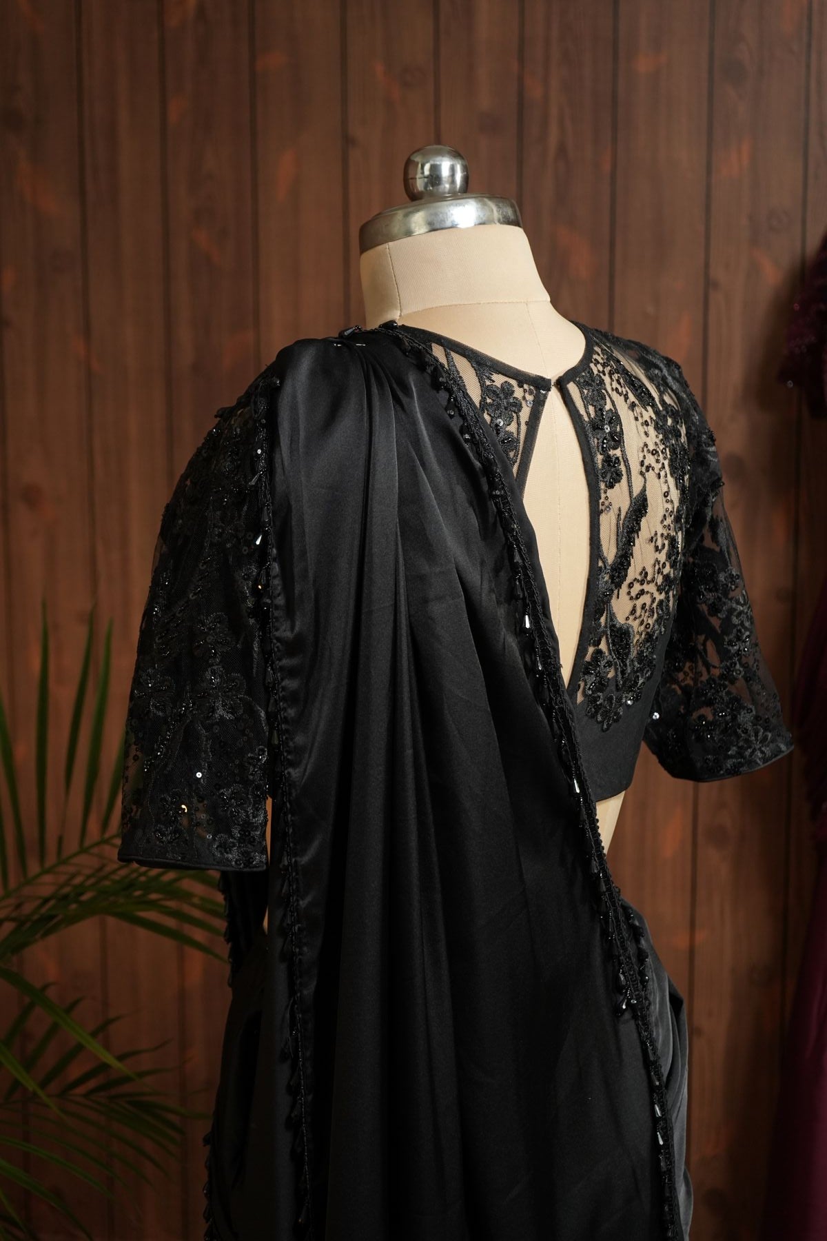 Front close-up of black sheer net blouse with floral sequin embroidery