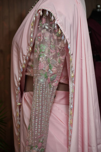 Front view of blush pink saree with layered ruffles and floral sequin full-sleeve blouse