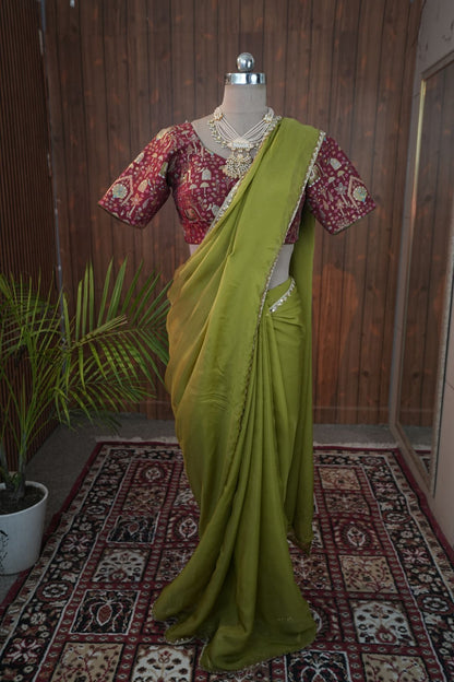 Close-up of olive green georgette saree border and maroon blouse