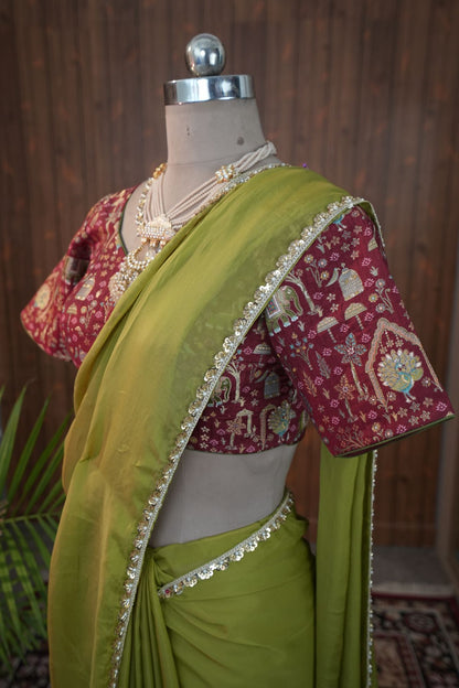 Maroon blouse with elephant bird and floral motifs and green sleeve edging