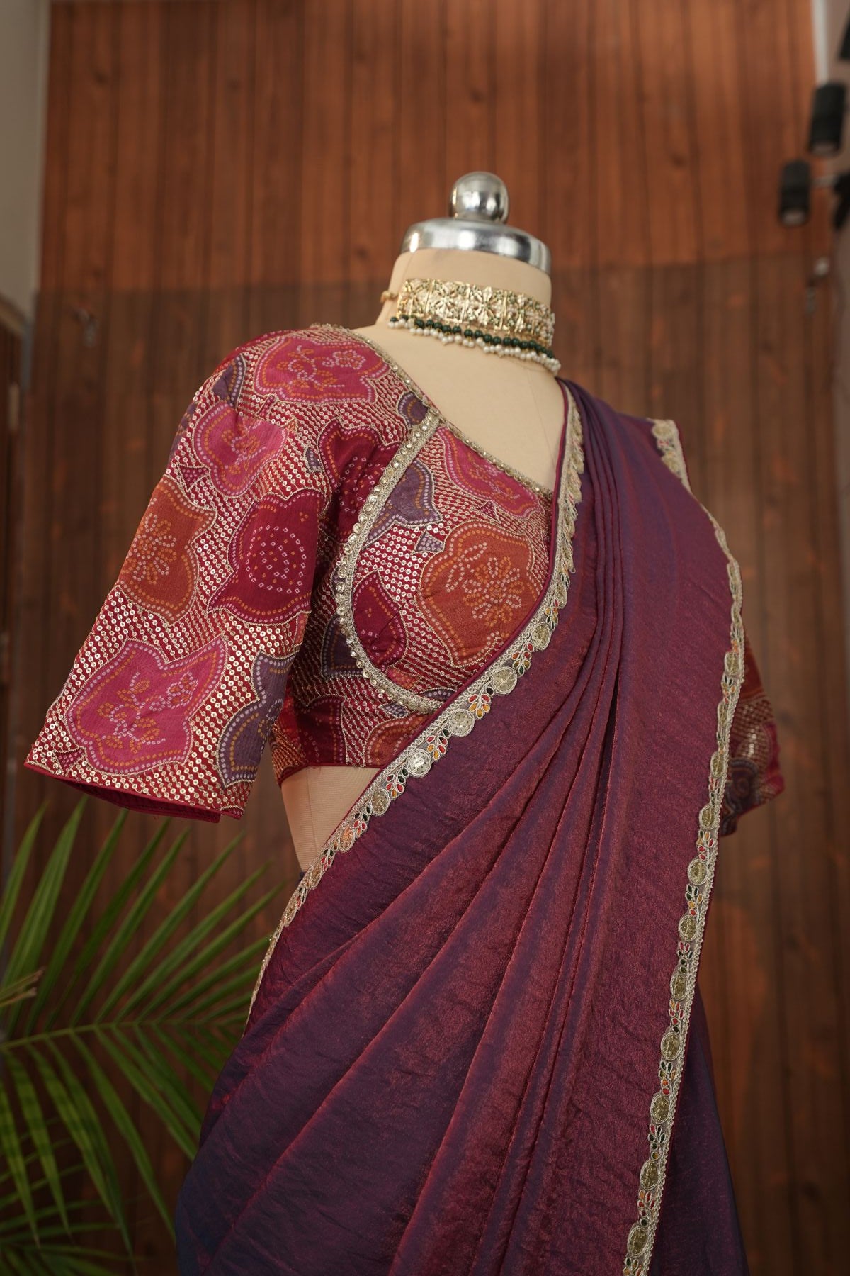 Full front view of plum Fendi saree with decorative border and patterned blouse