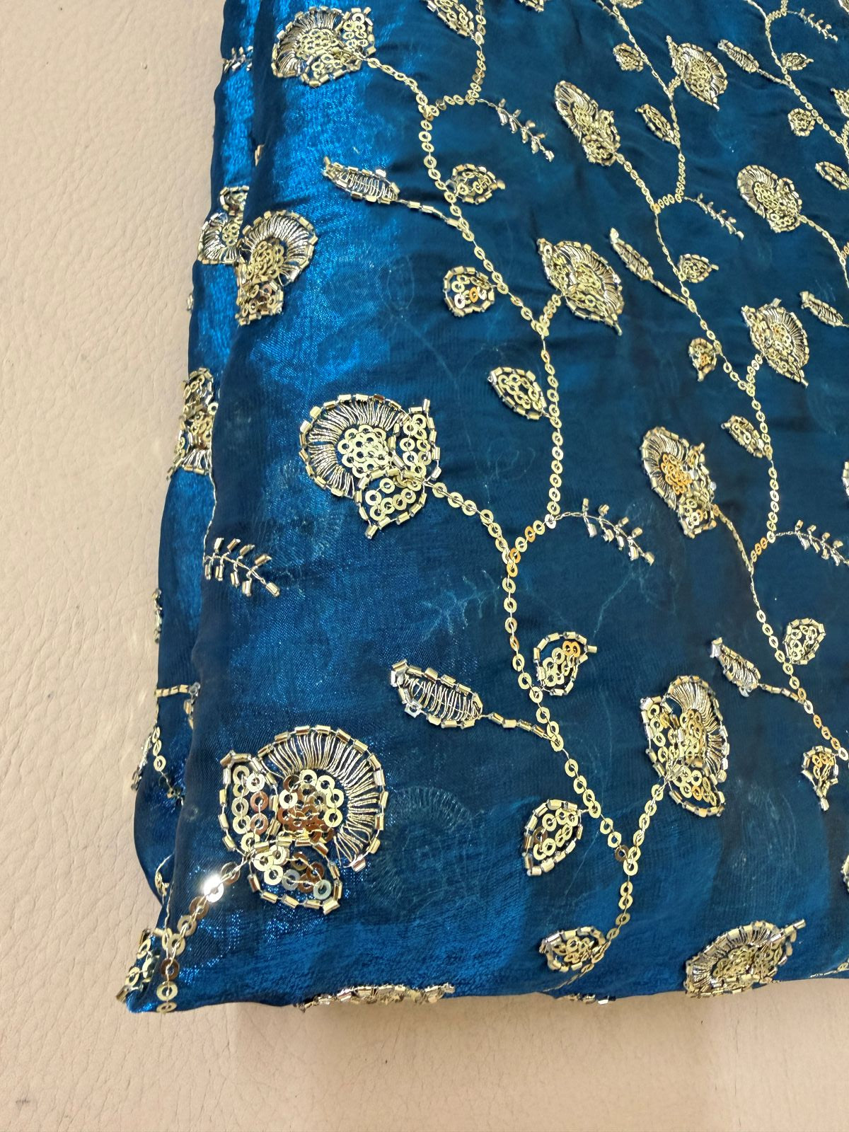 Royal blue floral embroidered lehenga skirt laid flat with gold detailing