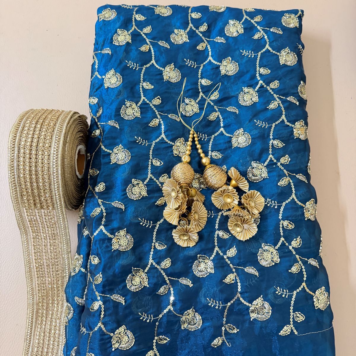 Royal blue floral sequin lehenga skirt with gold border and decorative tassels
