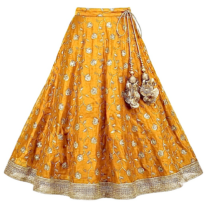 Mustard-gold floral lehenga skirt showing its flared silhouette, decorative waist tassels, and wide embellished border