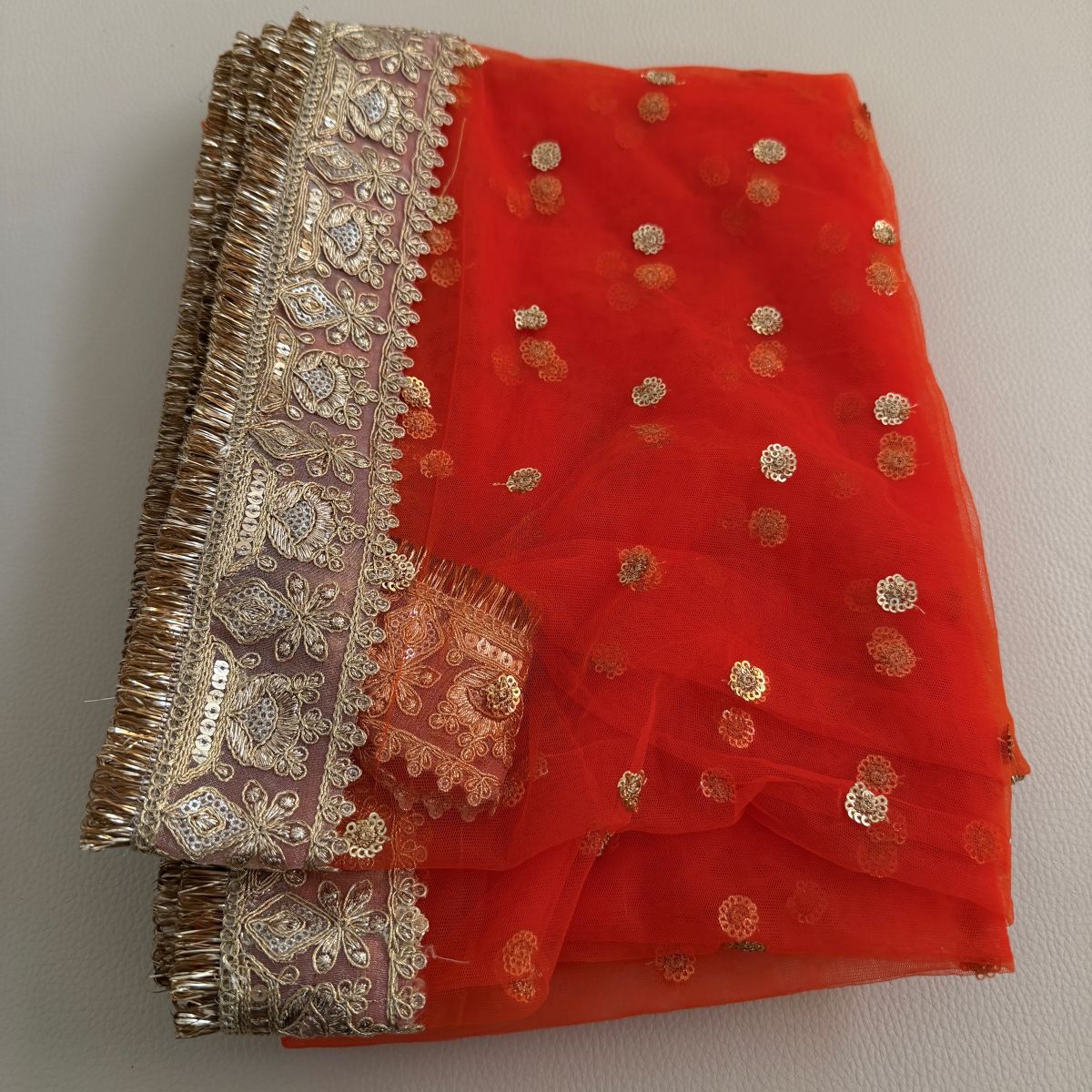 Orange embellished dupatta with scattered gold motifs and ornate gold border
