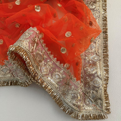 Draped orange embellished dupatta with gold-toned border