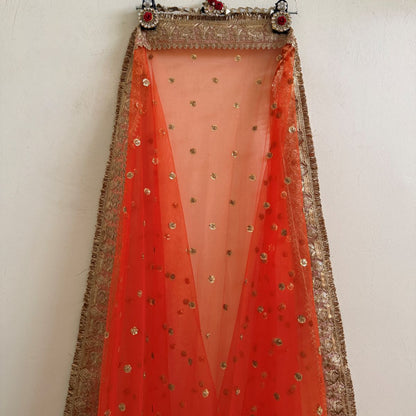 Full view of orange embellished dupatta with gold border and fringe