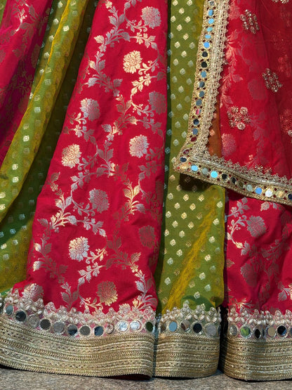 Back view of flared pink and green lehenga with gold-toned hem