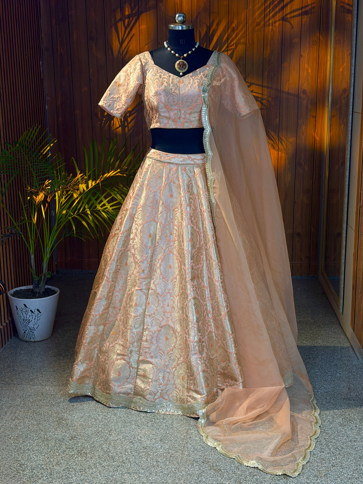 Peach and gold brocade lehenga set with sheer dupatta, full front view on mannequin