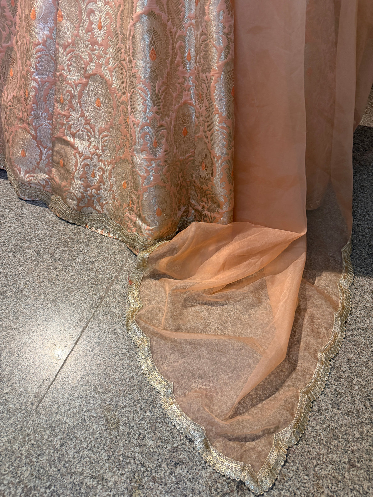 Close-up of lehenga hem and dupatta scalloped gold lace border