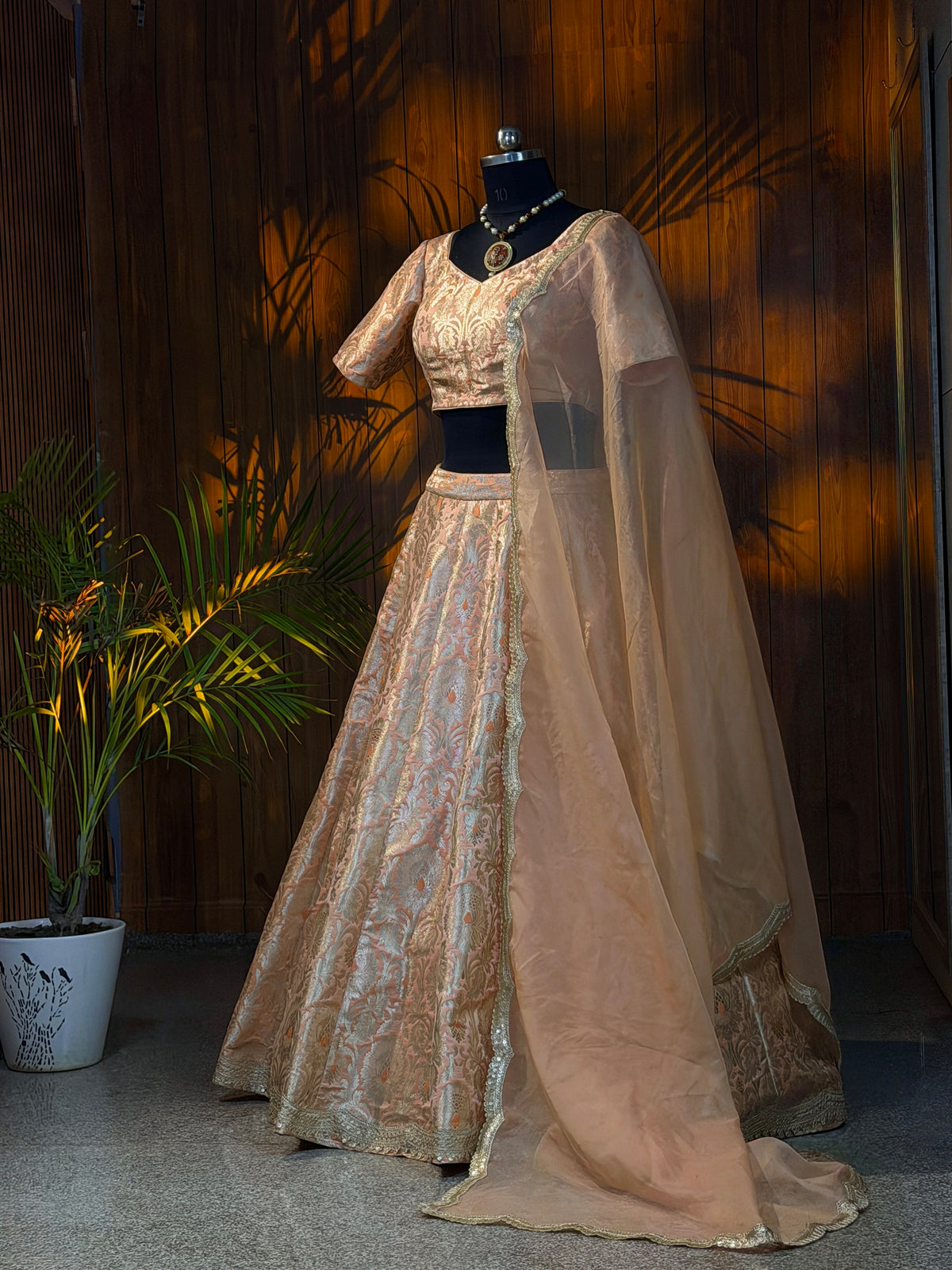 Front view of brocade blouse and lehenga skirt with pleated waist