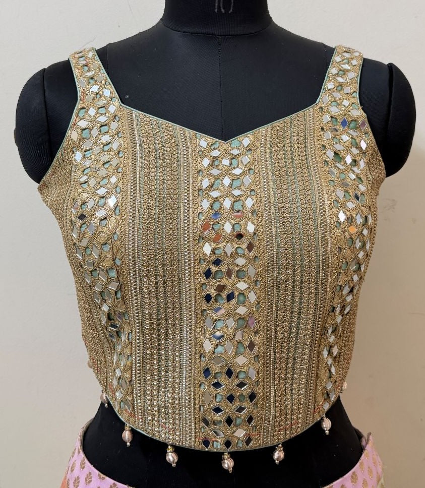 Front view of mint and gold mirrorwork corset-style blouse