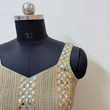 Close-up of gold embroidery and mirrorwork on blouse strap