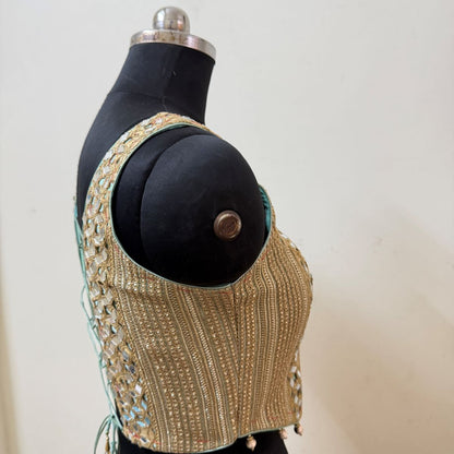 Side view of embroidered corset-style blouse