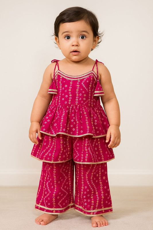 Baby wearing a pink patterned outfit on a white background