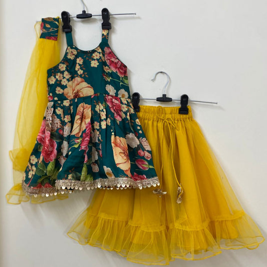 Children's floral dress with a yellow ruffled skirt on hangers against a white background