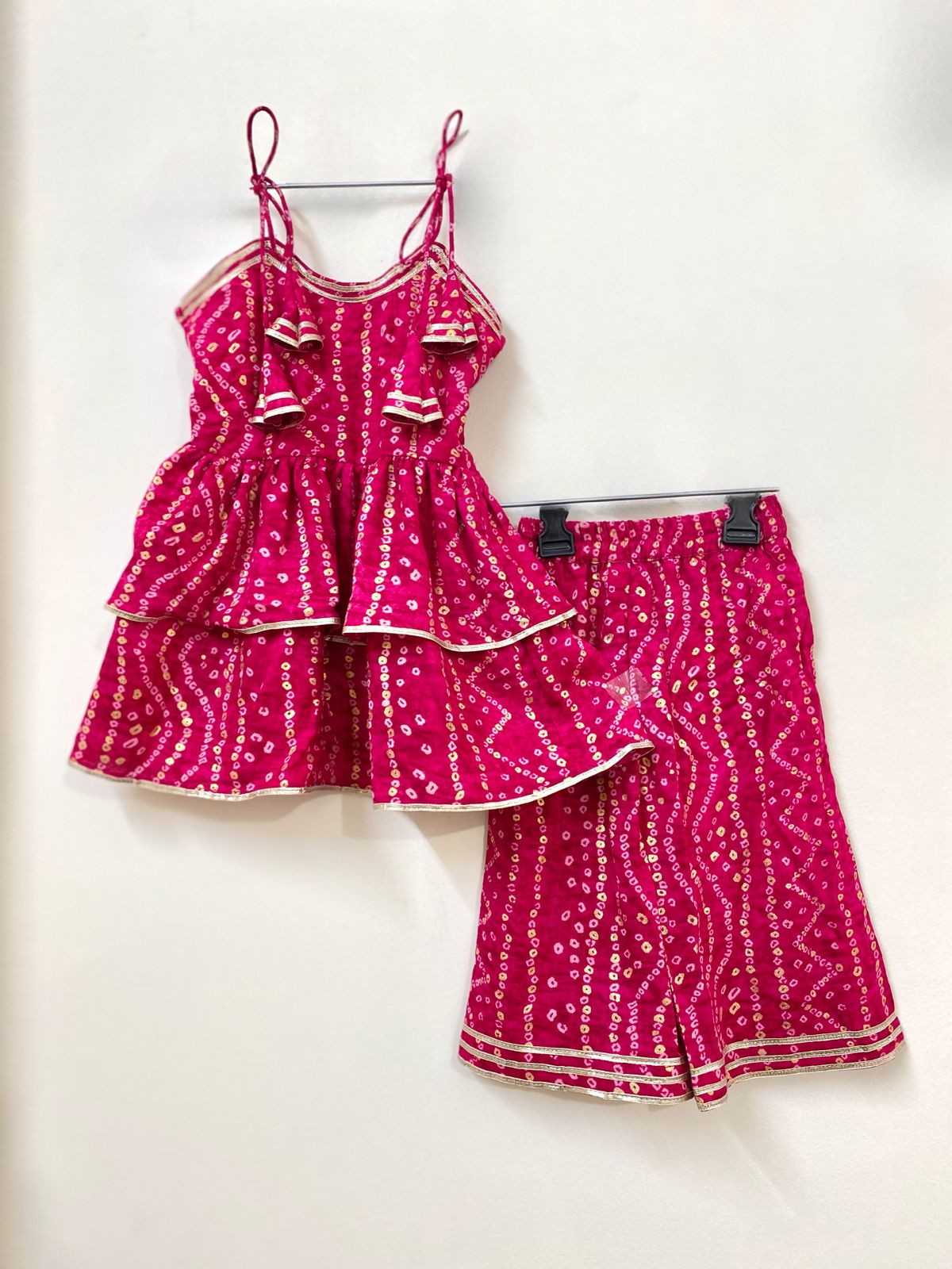 Pink patterned top and skirt set on a white background