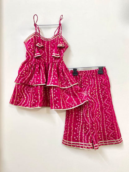 Pink patterned top and skirt set on a white background