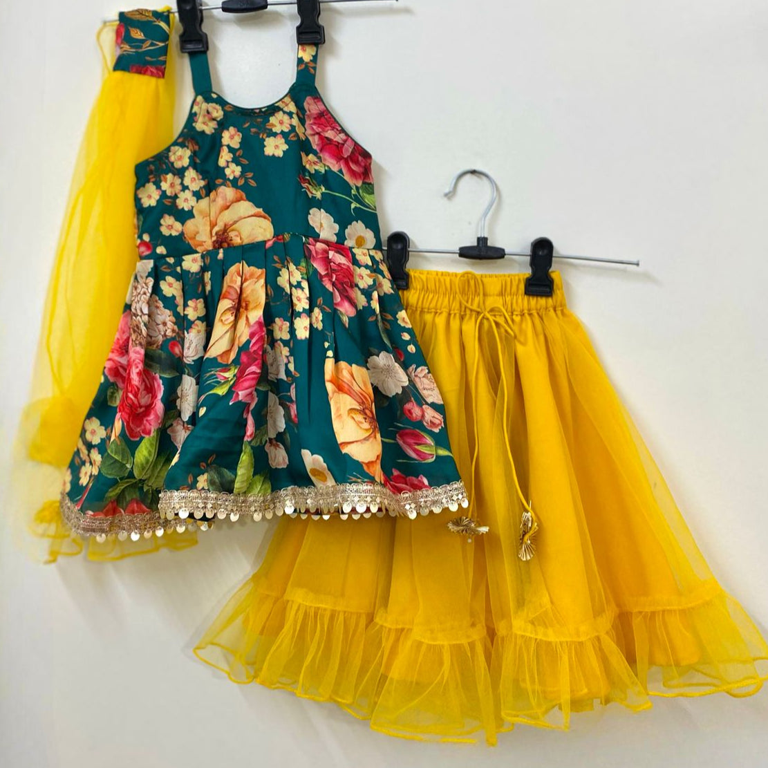 Floral dress with yellow ruffled skirt on a white background