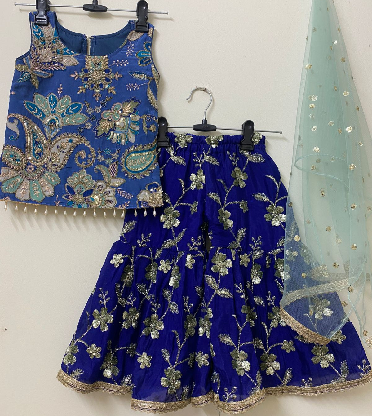 Blue embroidered traditional outfit with a dupatta on a white background