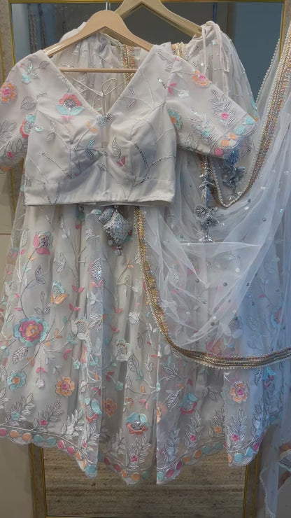Elegant White Net Embroidered Lehenga Choli with Colorful Floral Detailing – Festive & Wedding Wear