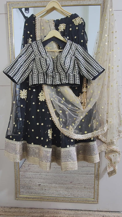Embroidered black lehenga with golden dupatta